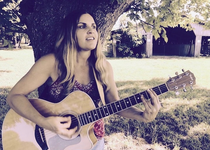 Jennifer Vazquez performing with guitar
